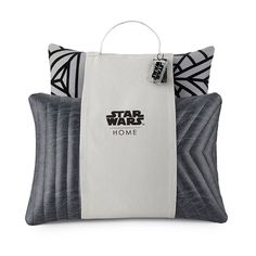 three pillows with star wars designs on them and one has a tag hanging from it