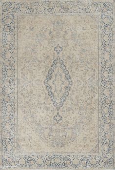 an antique rug with blue and beige colors