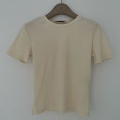 Zara Ivory Ribbed T-Shirt Slim Fit, Basic Classic Top Measurements: 13.5" Width, 19" Length Size Small Excellent Condition, No Signs Of Wear Nwot Always Check The Measurements And Photos And Feel Free To Message Me With Any Questions Cheap Cream Cotton T-shirt, Cream Short Sleeve Cotton T-shirt, Zara Stretch Crew Neck T-shirt, Beige Plain Short Sleeve T-shirt, Zara Stretch Short Sleeve T-shirt, Top Measurements, Ribbed Shorts, Zara Tops, Short Sleeve Top