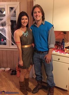 a man and woman standing next to each other in a room with wooden floors, white walls and cabinets