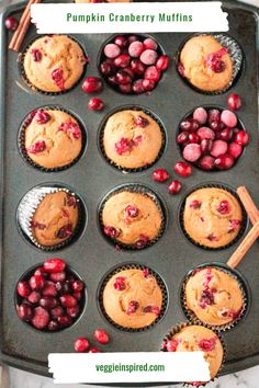 muffins with cranberries and cinnamon on top are sitting in a pan