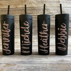 three black tumblers with gold lettering on them