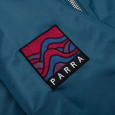 The By Parra Stacked Pets Varsity Jacket is a must-have outerwear apparel item. Composed of water-repellent nylon material, the design features an inner quilted lining. The design features Thinsulate insulation paired with embroidered branding and imagery at the front, sleeves, and rear. Two side pockets are placed, while the ribbed detailing at the neckline, cuffs, and hem offer a detailed touch. The button closure completes the design. 100% water-repellent nylon Front button closure Ribbed tri Teal Blue, Repellent, Water Repellent, Design Features, Insulation, Varsity Jacket, Branding, Water, Blue