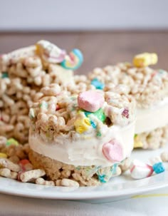 two pieces of cake on a plate with marshmallows and cereal toppings