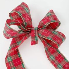 a red and green plaid bow on a white background