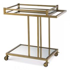 a gold metal and glass serving cart with two shelves on each side, one shelf is empty