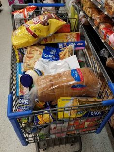 a shopping cart filled with food in a store