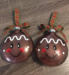 two christmas ornaments with faces painted on them