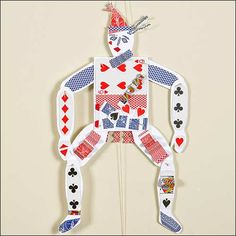 a paper cut out of a man with playing cards on it