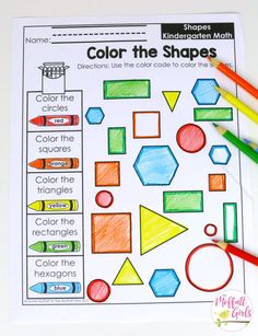 the color the shapes worksheet is shown with colored pencils on top of it