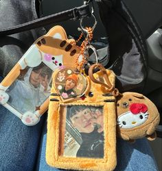 a cell phone keychain with an image of two people and a cat on it