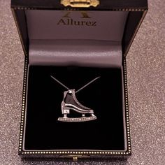 an ice skate necklace in a black box