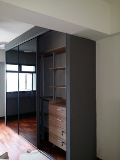 an empty room with sliding glass doors on the wall and wooden floors in front of it