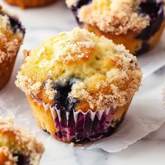 blueberry muffins with powdered sugar on top