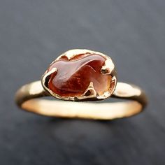 Lovely orange sapphire (home tumbled). I hand carved this setting in wax and cast it in recycled solid 18k yellow gold using the lost wax casting process. This one-of-a-kind raw gemstone ring is a size 7 it can be resized up or down for you as needed. The sapphire stone measures about 11mm X 5mm. Throughout all time and history in every tribe and culture all around the world crystals, minerals and gemstones have been used for healing, luck, divination, adornment vibrational medicine and so much Raw Engagement Ring, Orange Engagement Ring, Vibrational Medicine, Raw Gemstone Ring, Wax Casting, Orange Sapphire, Lost Wax Casting, Minerals And Gemstones, Sapphire Stone