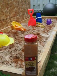 a bottle of brown liquid sitting on top of a wooden table