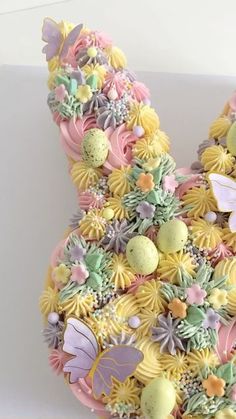 a cake shaped like an easter bunny made out of cupcakes