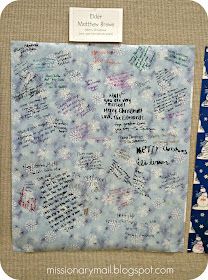 a piece of fabric with writing on it and snowflakes around the edges in blue