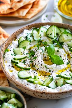 cucumber and olive dip with pita bread on the side, ready to be eaten