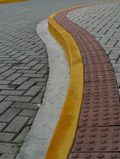 a red fire hydrant sitting on the side of a road next to a yellow curb