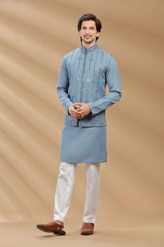 Top Details Color- Denim Blue, Fabric - Light weight suiting fabric With Embroidered Bottom Details Color- White, Fabric - Dhupion Silk, Style - Aligadi Pajama Package Include :INCLUDES 1 BANDI,1 KURTA,1 ALIGADI. Turban ,Mojari And Other Accessories Are Not Sold Along With The Dress. CARE: DRY CLEAN ONLY Additional Information : - As This Sherwani/Waistcoat/Kurta Are Made As Per Orders So It Is Strictly Not Acceptable Once Get Delivered .So Kindly Choose Body Fit Size . Also We Keep 2 Inches Ext Blue Nehru Jacket With Chikankari Embroidery For Festivals, Traditional Blue Nehru Jacket For Designer Wear, Traditional Blue Nehru Jacket In Straight Kurta Style, Designer Blue Nehru Jacket With Traditional Drape, Blue Cutdana Nehru Jacket For Festivals, Blue Nehru Jacket For Festivals, Blue Unstitched Nehru Jacket With Dabka, Blue Kurta With Nehru Jacket For Men, Blue Nehru Jacket Straight Kurta For Festivals