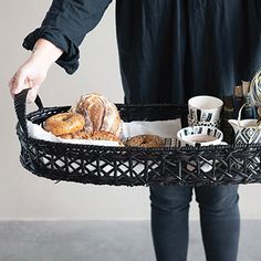 a person holding a basket with food in it