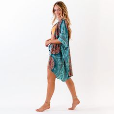 Indulge in comfort and luxury with the Lotus & Luna Canggu Kimono. Perfect for any occasion, this versatile kimono can be dressed up or down to elevate your style. Made with machine-washable 100% rayon, it's easy to care for and features a flattering fit for sizes S to 3X. Available in stunning orange and teal, you'll be sure to turn heads wherever you go. Flowy Cover-up With Kimono Sleeves For Loungewear, Flowy Rayon Wrap Kimono, Casual Wrap Kimono In Rayon, Relaxed Fit Wrap Kimono For Beach Cover-up, Relaxed Fit Wrap Kimono For Beach, Printed Summer Outerwear For Beach, Flowy Wrap Beach Robe, Beach Kaftan With Kimono Sleeves In Rayon, Flowy Open Front Beach Robe