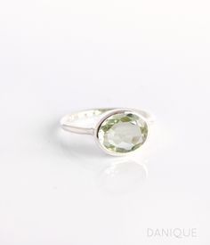 Experience the enchanting light green hue of this Green Amethyst Quartz ring. The perfectly sized oval gemstone adds a touch of elegance to any jewelry collection. A popular choice for February birthdays and Amethyst enthusiasts, this ring features a flawless, transparent green gemstone that is beautifully faceted and bezel-set. Available in either 925 sterling silver or 18k vermeil gold, this exquisite piece makes an ideal birthday gift or a special treat for anyone who appreciates the delicate beauty of Green Amethyst. Gemstone is approximately 8 x 12mm. Band has 925 stamp on inside. Please note that each ring is handmade and there may be some slight variations from listing photo. Available in: ✦ 18K VERMEIL GOLD. ✦ ROSE GOLD.  ✦ BRIGHT STERLING SILVER.  We have these rings available in Classic Green Amethyst Ring As Gift, Classic Green Amethyst Ring Gift, Classic Green Amethyst Ring For Gift, Oval Green Amethyst Jewelry, Green Oval Amethyst Ring For Anniversary, Green Amethyst Oval Ring For Anniversary, Green Amethyst Ring Gift, Green Amethyst Gemstone Ring As Gift, Green Oval Amethyst Ring For Wedding