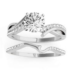 a white gold engagement ring set with a round diamond in the center and two matching bands