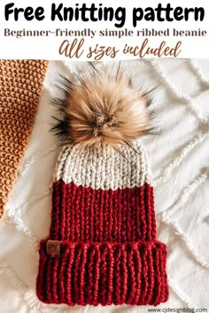 a red and white knitted hat with a pom - pom on top