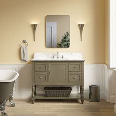 a bathroom with a tub, sink and mirror