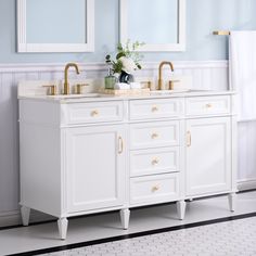 a bathroom with two sinks and mirrors on the wall