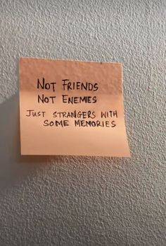 a sticky note attached to the wall saying not friends not enemys just strangers with some memories