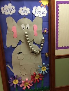 a door decorated with paper flowers and an elephant