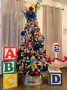 a decorated christmas tree with toys around it