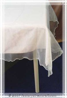 a white table cloth on top of a wooden chair