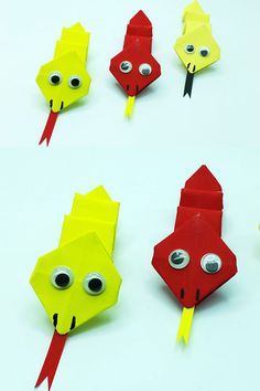 four origami fish made out of paper with googly eyes