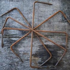 an old rusted metal object sitting on top of a wooden table