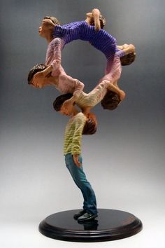 two figurines are holding each other in the air