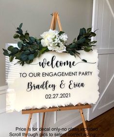 a welcome sign with flowers and greenery on it for an engagement or bridal party