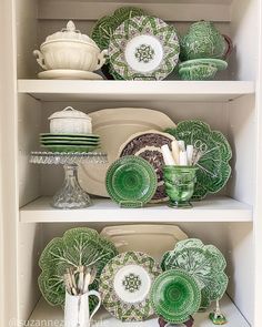 green dishes and plates on shelves in a cabinet