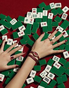 woman's hands surrounded by green and white dices with symbols on each side