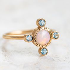 Our Royale Ring is set with a crystal opal surrounded by aquamarines. Opal measures 5.5mm. Aquamarines measure 2.5mm. Bandwidth 1.8mm. Pictured with a matte finish. For a high shine finish, please leave a note at checkout. Stone Ring Design, Crystal Opal, Aquamarine Ring, Jewelry Lookbook, Hollywood Glam, Aqua Marine, Aquamarine Rings, Opal Crystal, Perfectly Imperfect