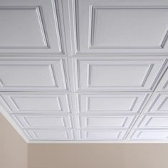 an empty room with white ceiling tiles on the ceiling, and no one is in it