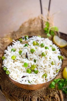 white rice and peas in a wooden bowl