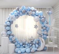 a blue and silver balloon arch with stars