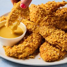 fried chicken with dipping sauce on a white plate