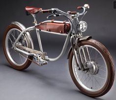 an old fashioned bicycle is shown on a gray background with brown leather seat and handlebars