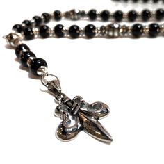 Rosary “Fleur de lis” - ROS441 (has a matching Bracelet US$ 65.00 - 8” - bracelet is not included in the Rosary Price) Handcrafted in store, this rosary style Onyx necklace is accented with hematite & steel beads and a matching bracelet. A look wouldn’t be complete without a ring! A powerful protection stone, Black Onyx absorbs and transforms negative energy, and helps to prevent the drain of personal energy. It aids the development of emotional and physical strength and stamina, especially The Rosary, Onyx Necklace, Protection Stones, Matching Bracelet, Custom Motorcycles, Matching Bracelets, Rosary, Black Onyx, Semiprecious Stones