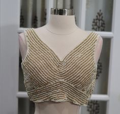 Elegant Bead work Blouse across entire blouse in Gold and Pearl color.size:36 Elegant Sleeveless Blouse With Pearl Embroidery, Elegant Sleeveless Blouse With Sequins, Elegant V-neck Sequined Blouse Piece, Sleeveless Party Blouse With Pearl Embroidery, Elegant Embellished Sleeveless Blouse, Sleeveless Beaded Tops For Wedding, Elegant Beaded V-neck Tops, Fitted Beaded V-neck Blouse, Fitted Sleeveless Top With Pearl Embroidery